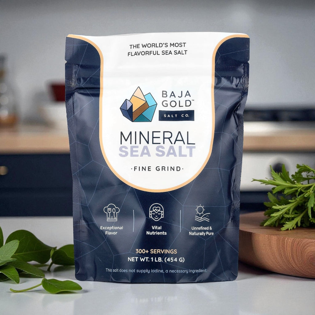 Baja Gold Mineral Sea Salt package on a kitchen counter with herbs in the background