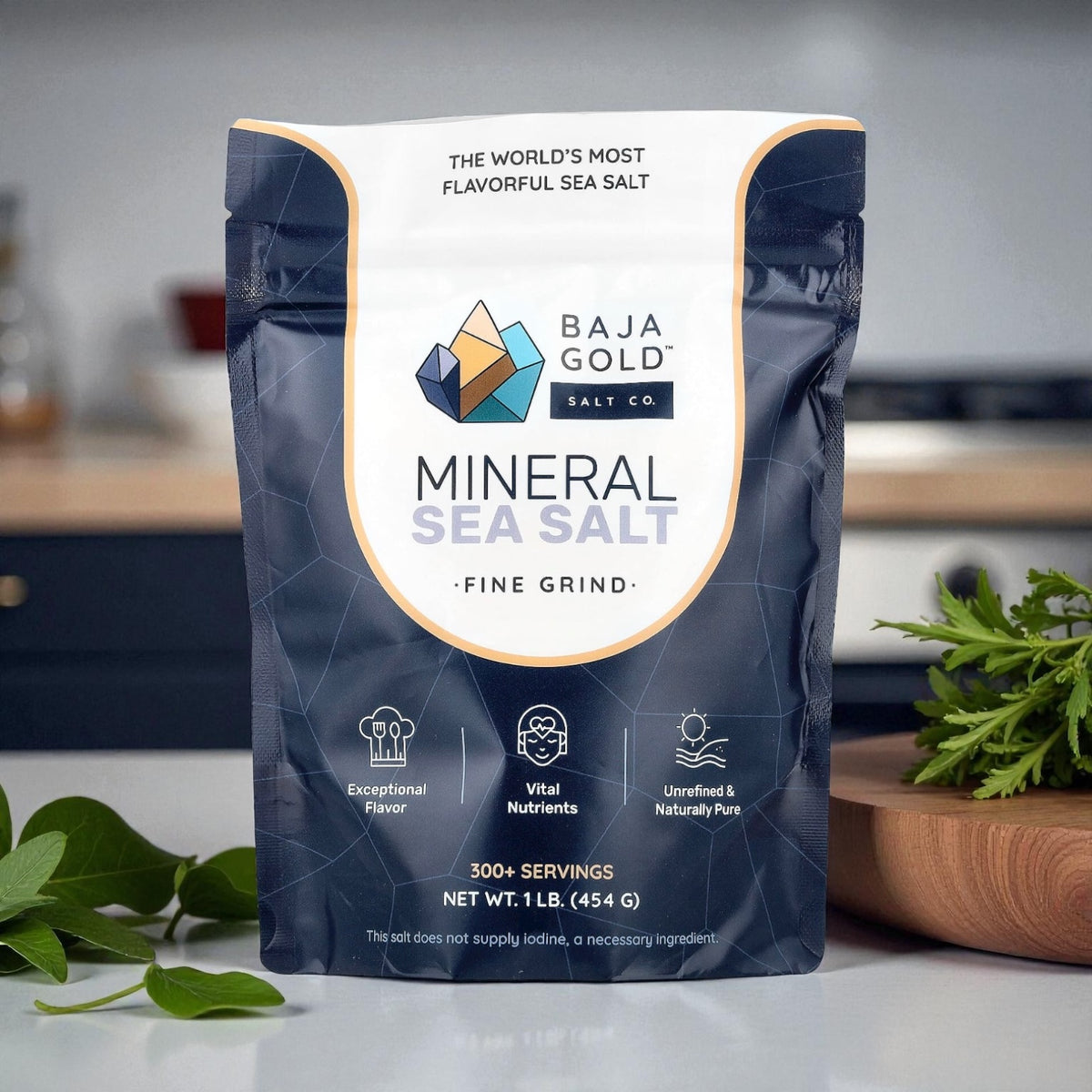 Baja Gold Mineral Sea Salt package on a kitchen counter with herbs in the background